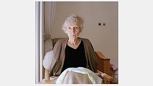 Künstlerisches fotografisches Portrait einer eleganten alten Dame im Lehnstuhl 